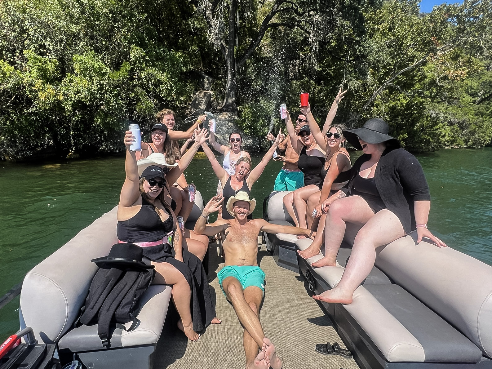 a group of people sitting on a boat in the water