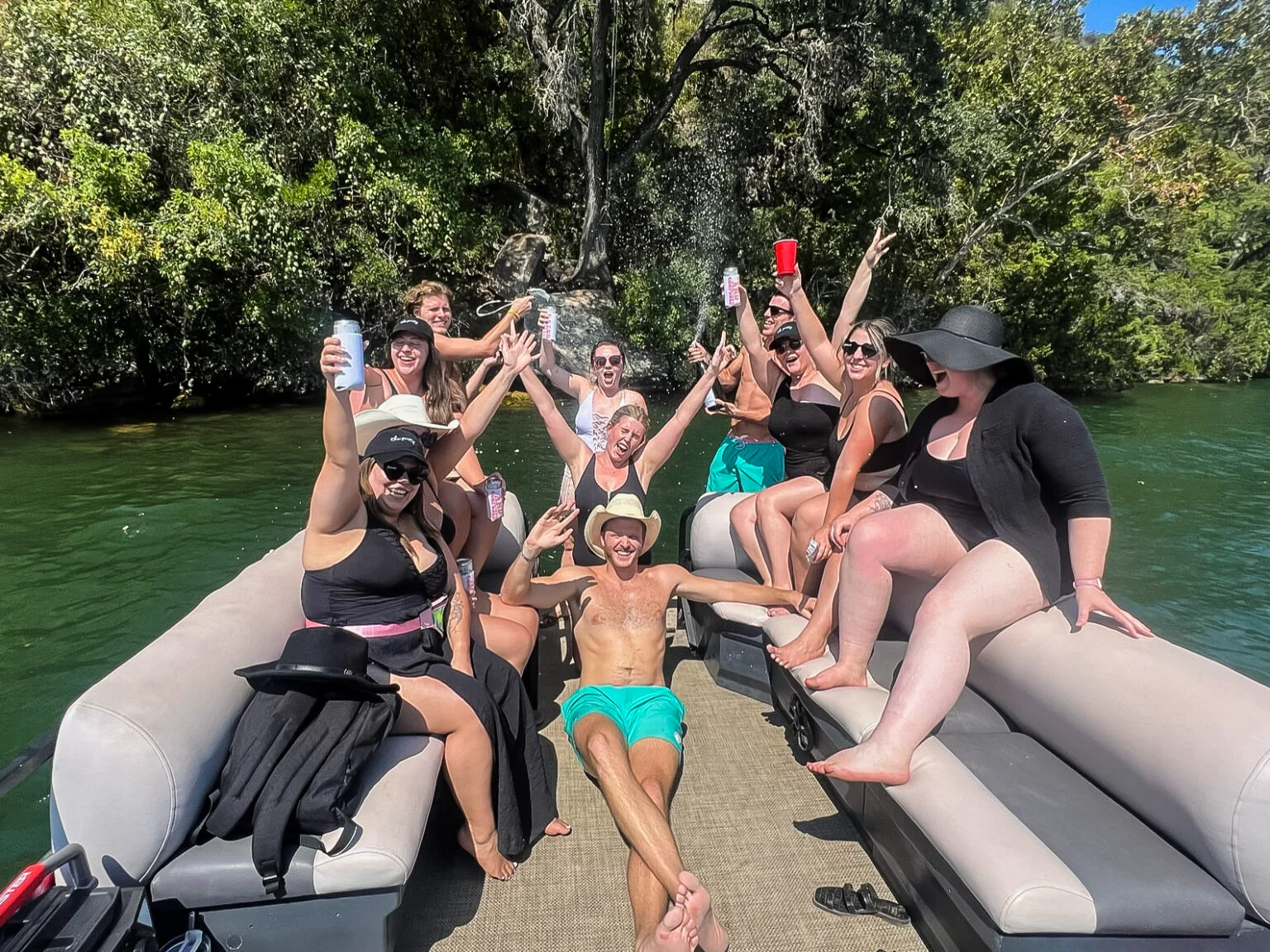 a group of people sitting on a boat in the water