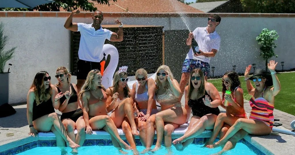 a group of people sitting in a pool