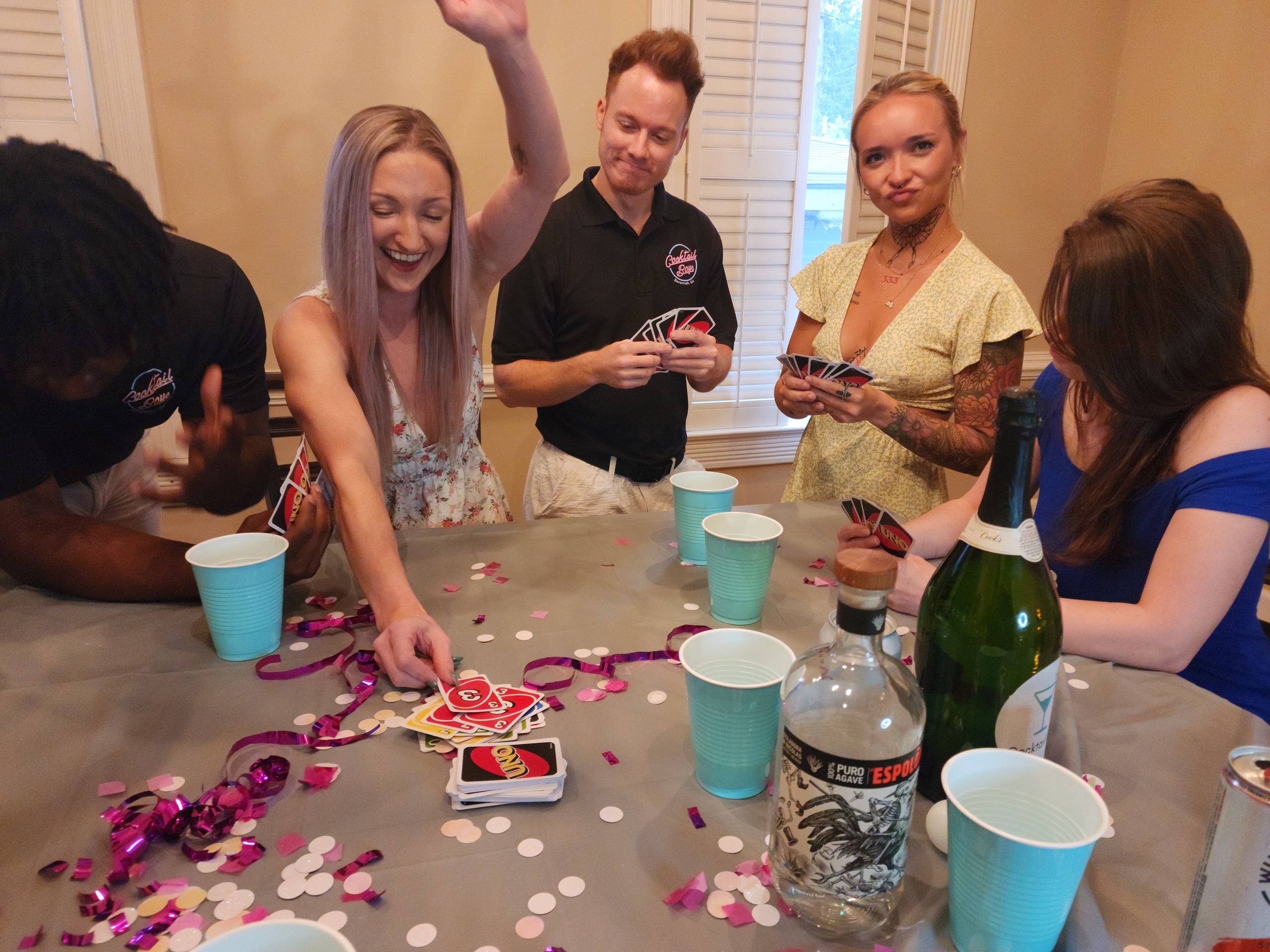 Victoria Helyar et al. sitting at a table with a cake