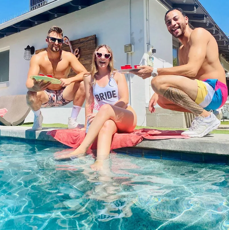 a group of people swimming in a pool of water