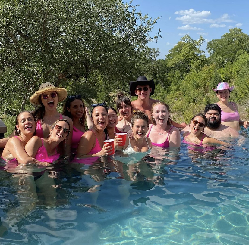 a group of people swimming in a pool of water