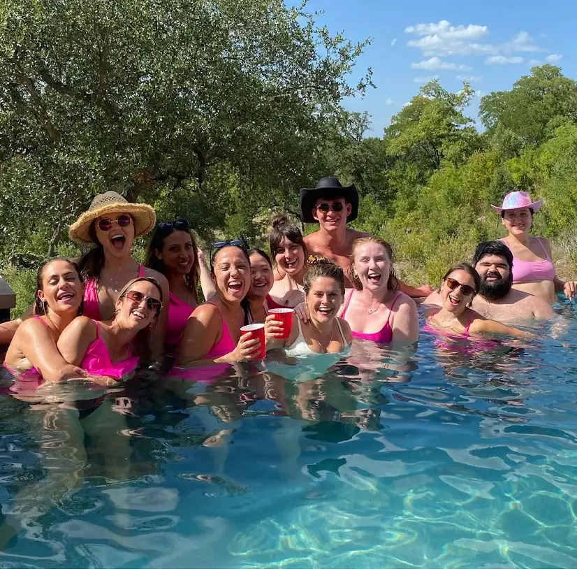 a group of people swimming in a pool of water