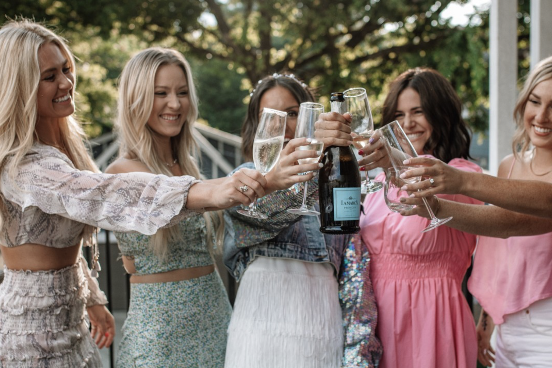 a group of people holding wine glasses
