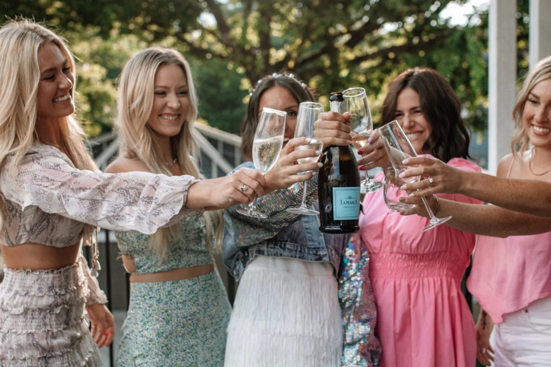 a group of people holding wine glasses