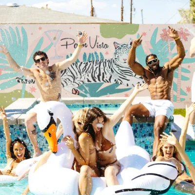 Pura Vida Bachelorette party group with shirtless Cabana Boys host and swan pool float