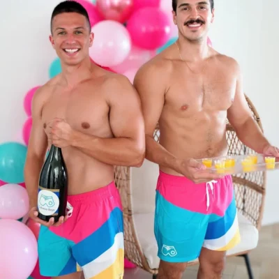 Cabana Boys host smiling at camera holding a coffee mug and donut at a poolside event