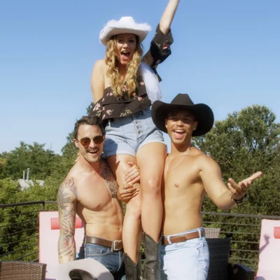 A Cocktail Cowboys host in a cowboy hat jumping and celebrating with a bachelorette group outdoors