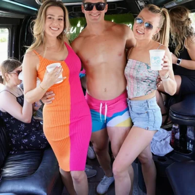 A woman in a white outfit posing inside a party bus with Cabana Boys branding