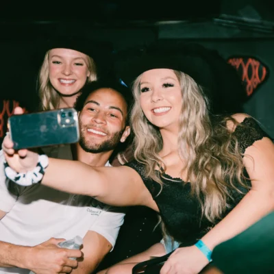 A Cabana Boys host taking a selfie with two smiling women inside a party bus