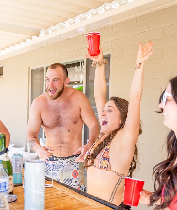 Woman greeting guests at party entrance