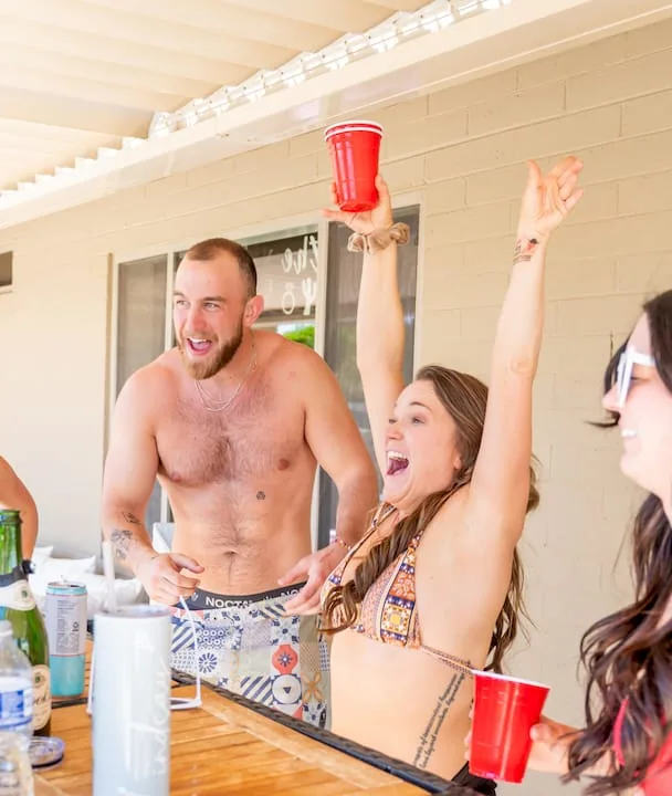 Woman greeting guests at party entrance