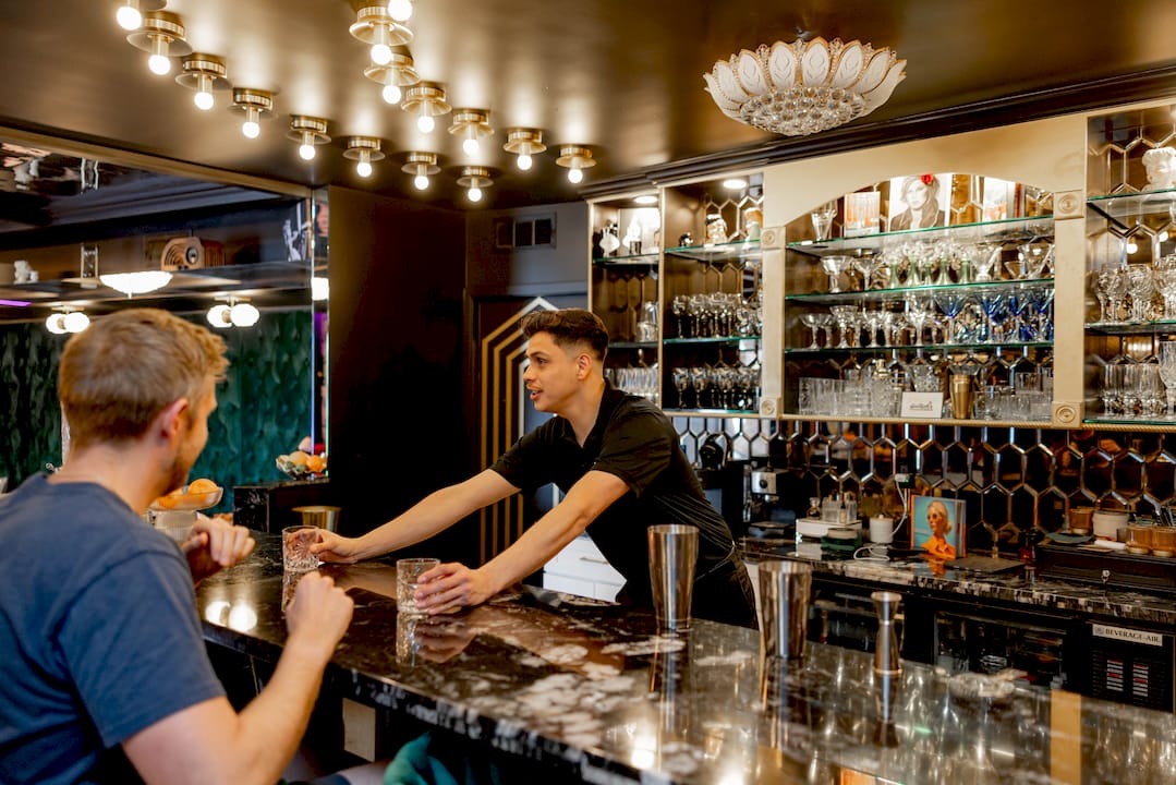 Bartender preparing portable bar setup indoors
