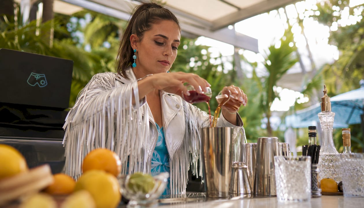 Cocktail party host serving themed drinks