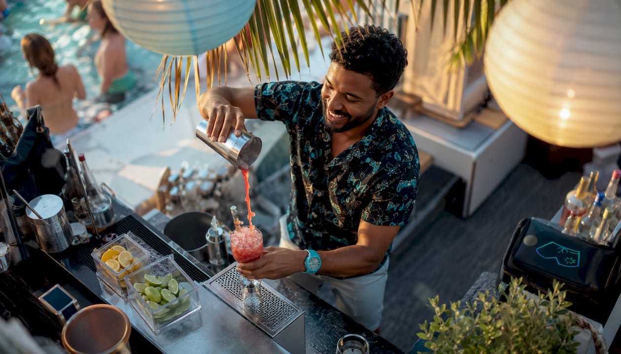 Bartender preparing cocktails at pool party
