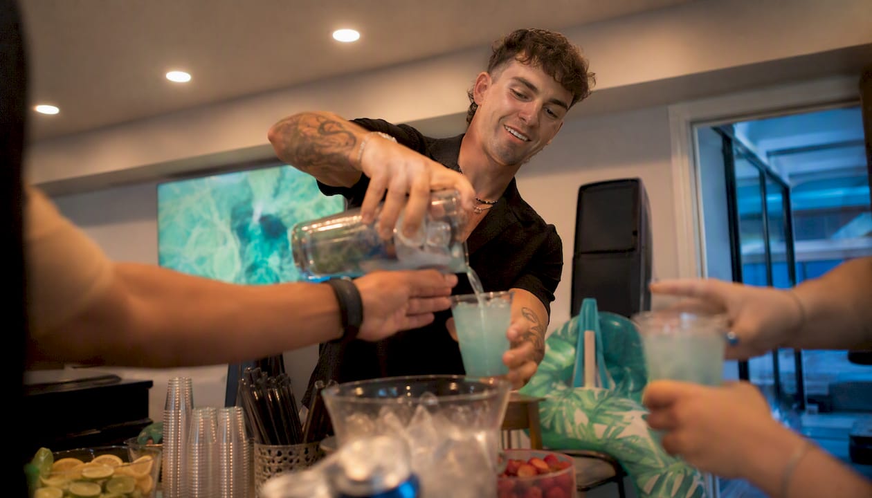 Private host pouring cocktail at party bar