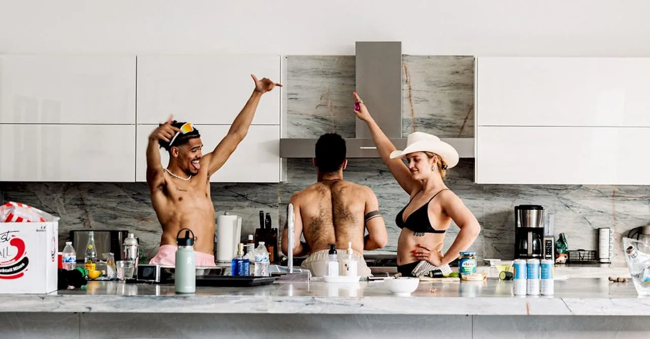 Diverse party hosts engaging guests poolside